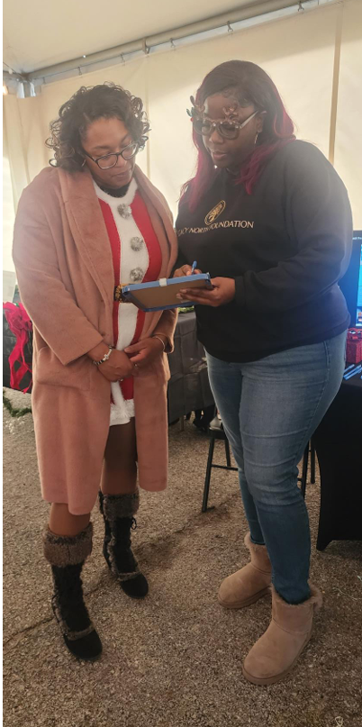 Legacy North Foundation volunteer helping a community member complete a form