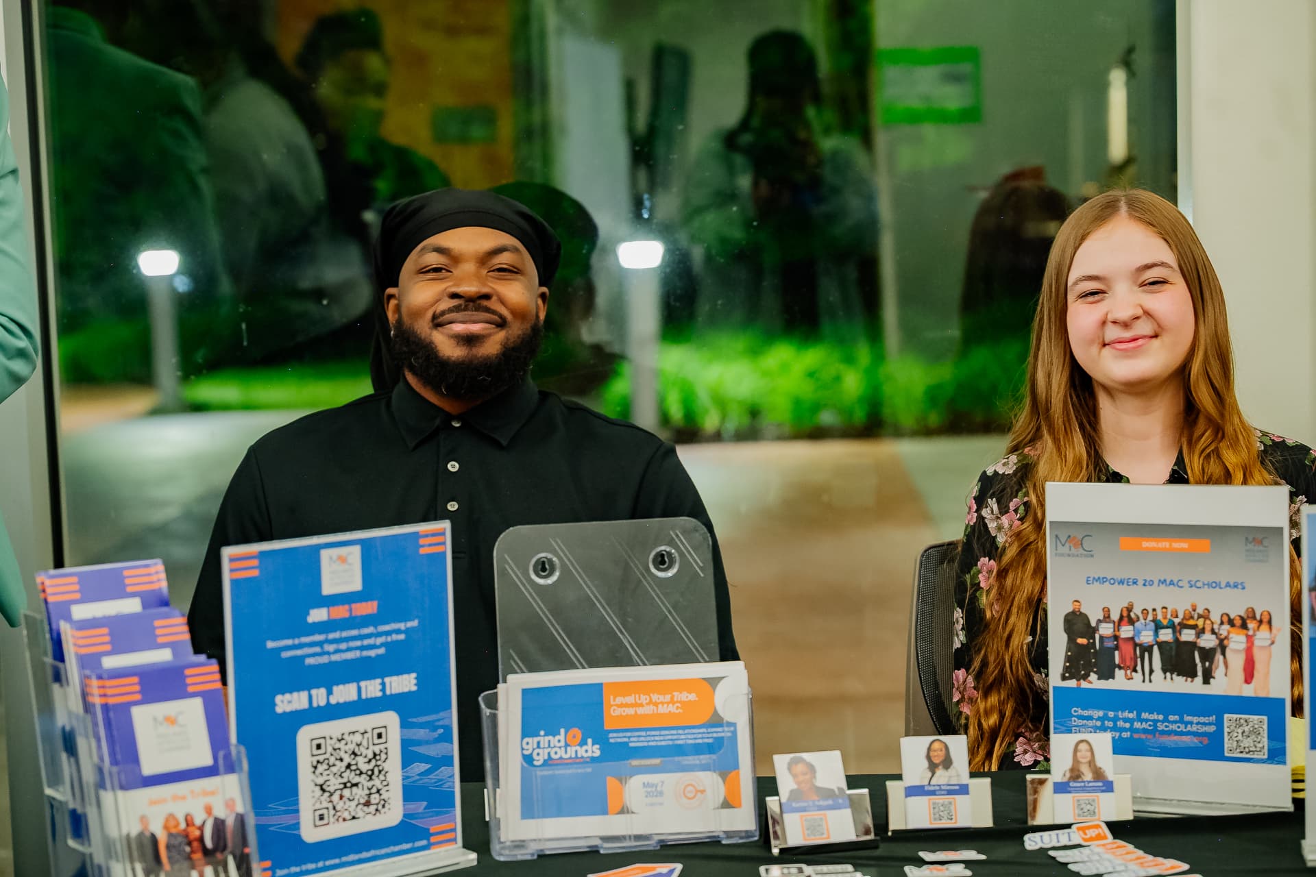 Volunteers welcoming attendees at a community resource fair table