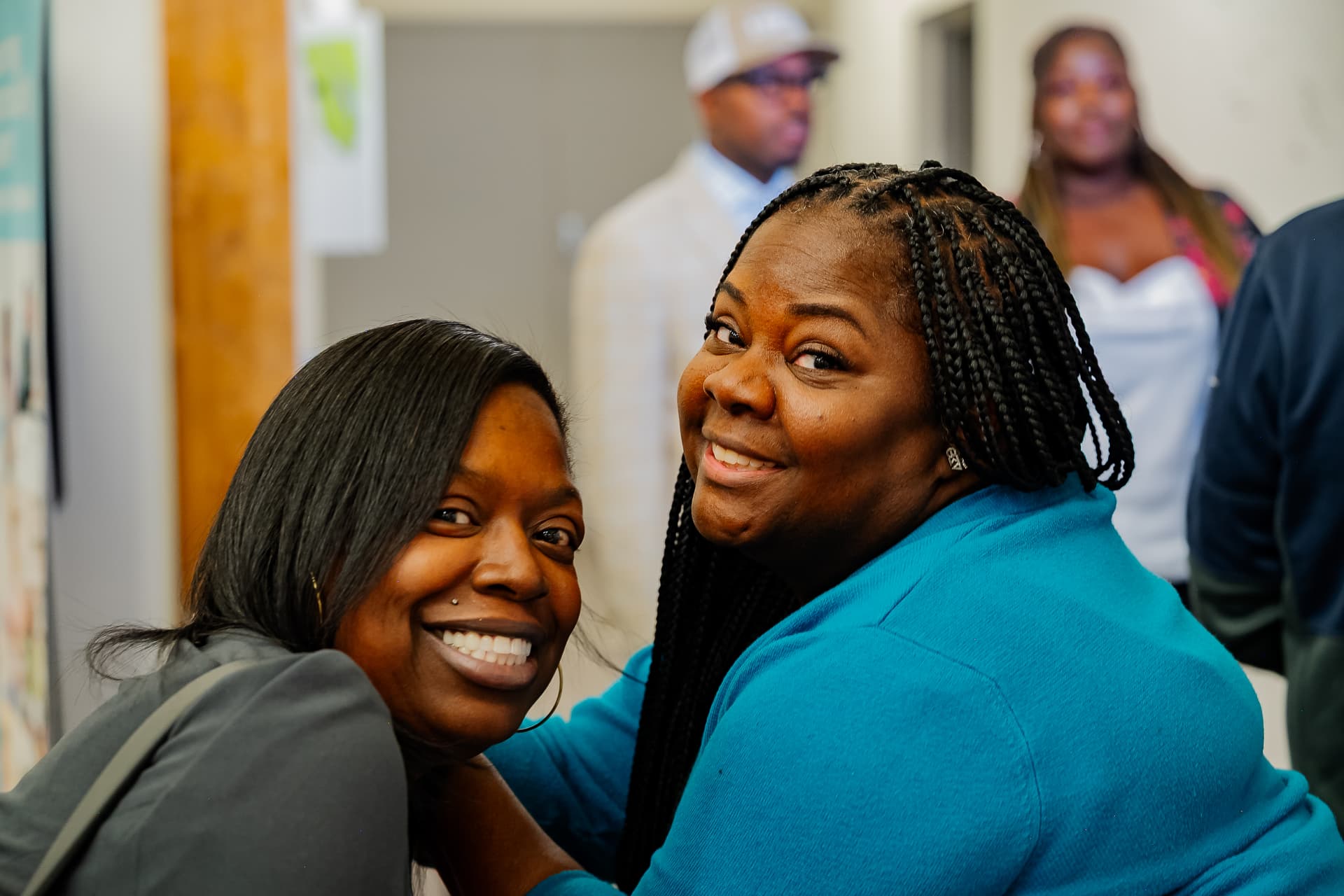 Two attendees smiling together at the community resource fair