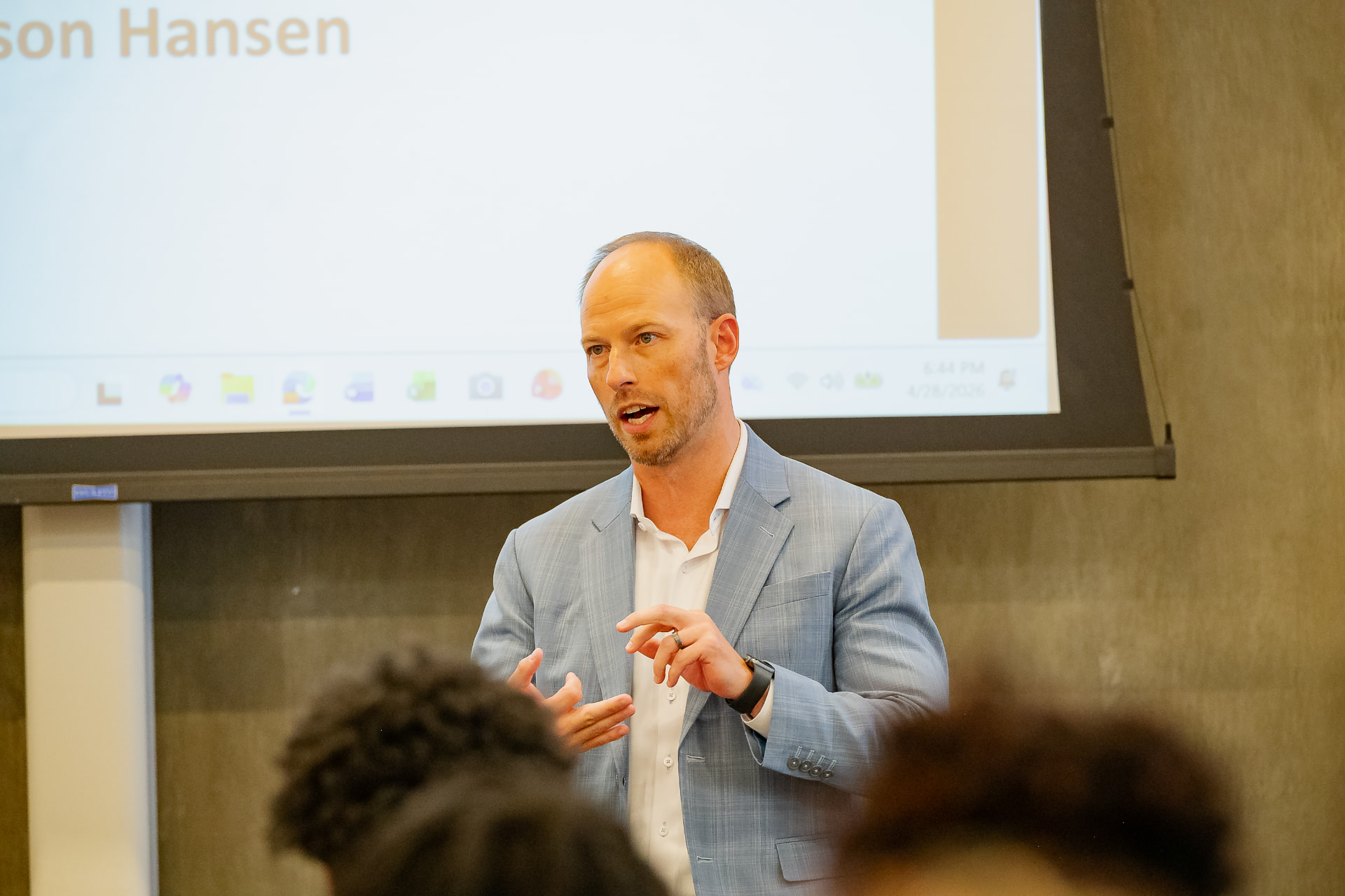A presenter speaking to participants during a financial literacy session