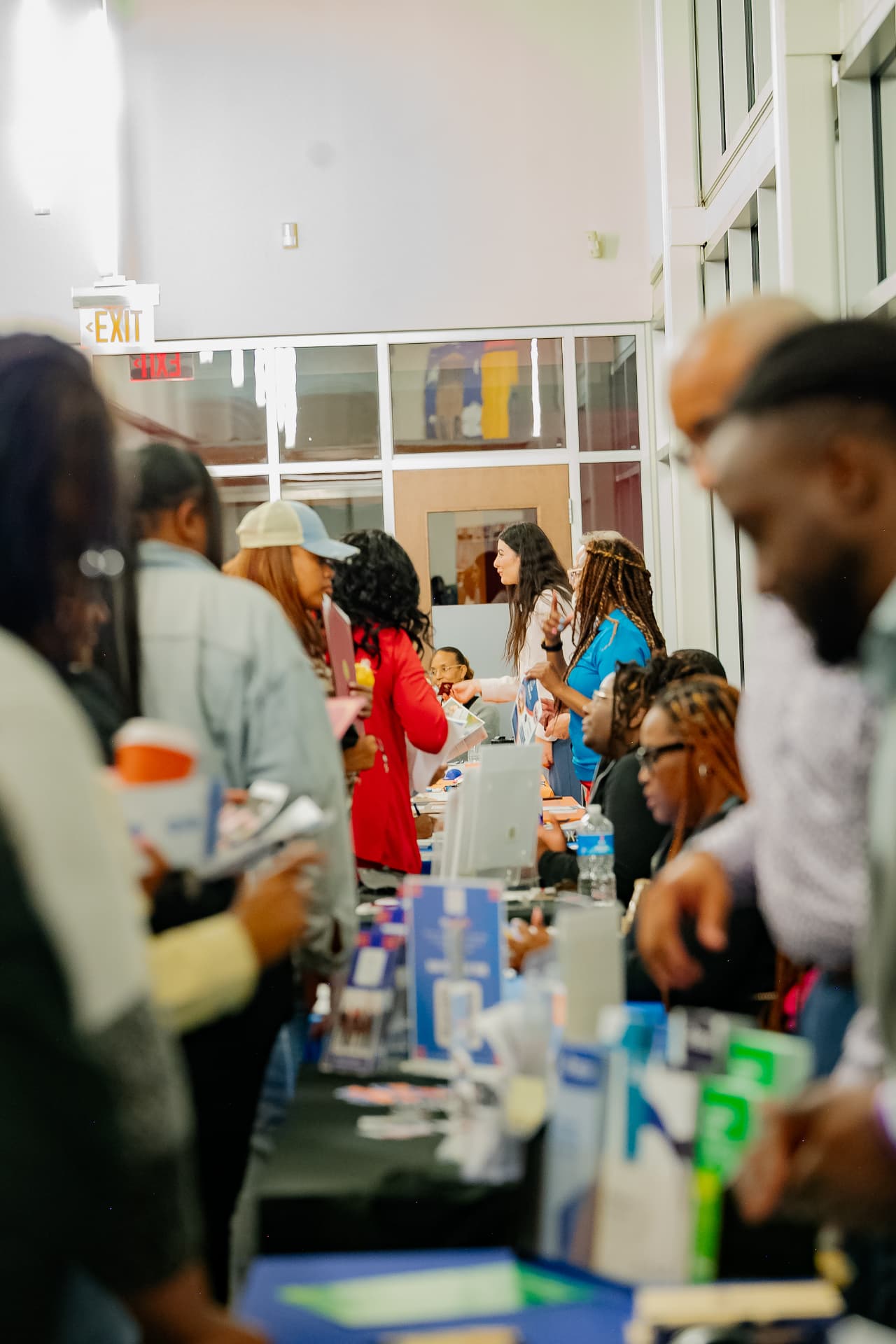 Attendees visiting partner tables at the community resource fair