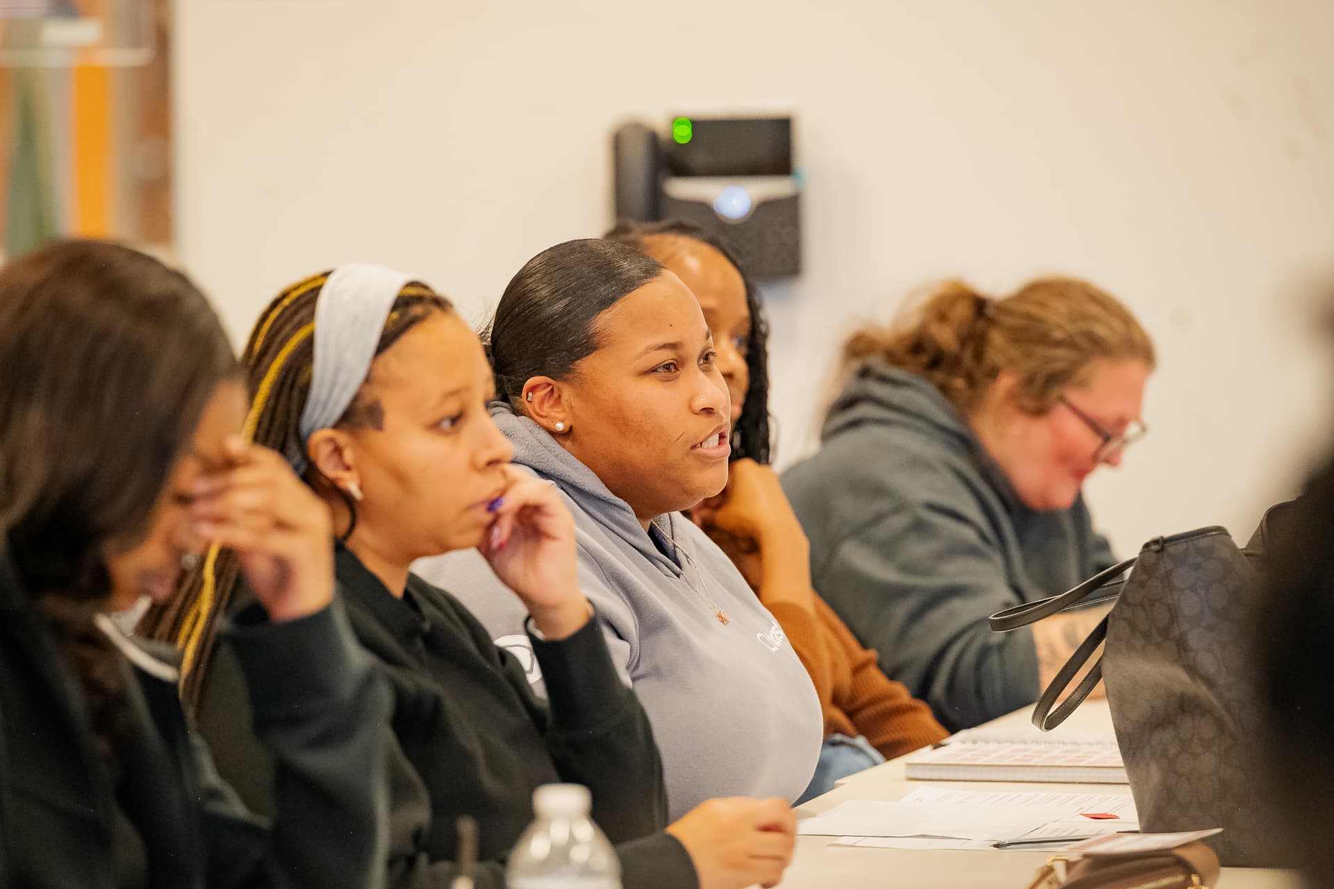 Participants listening and taking notes during a session