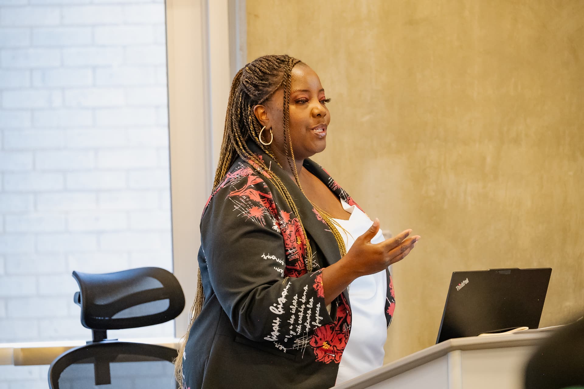 A presenter speaking with participants during a session