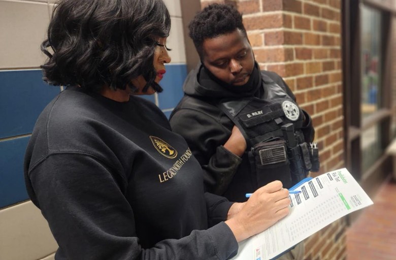 Legacy North Foundation volunteer reviewing resource information with an attendee