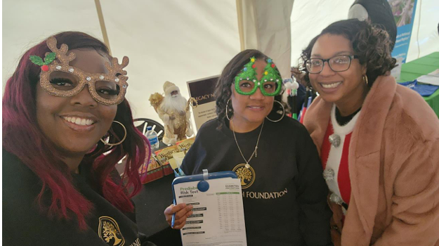 Legacy North Foundation volunteers holding a prediabetes risk test at a holiday event