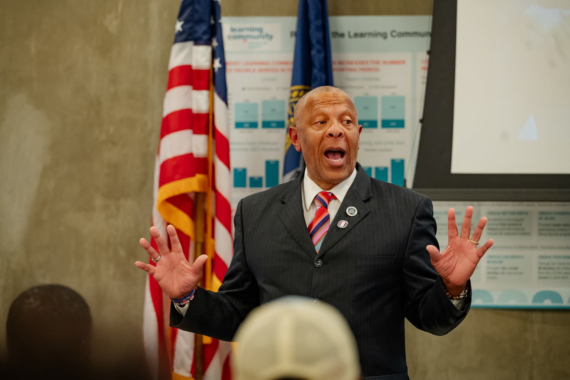 A community leader speaking to the room during the program